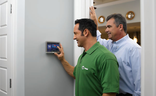 Trane Dealer Showing Customer How To Use Thermostat